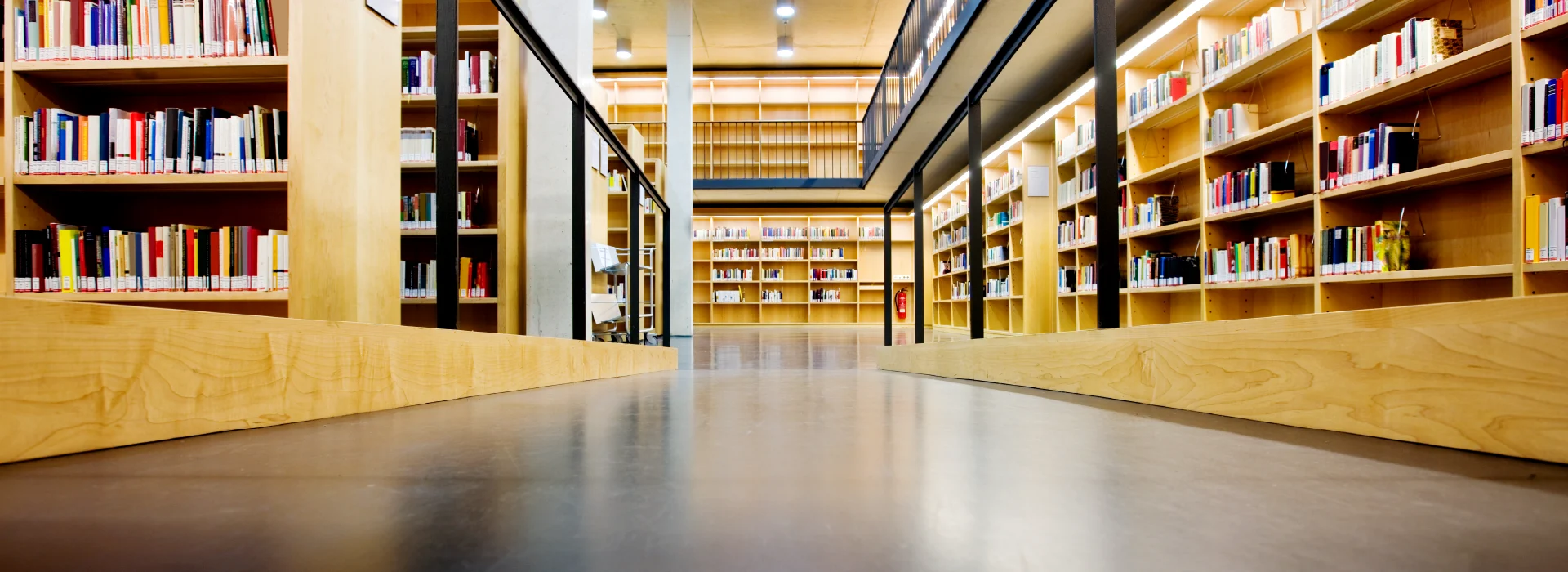 A stunning Bona resilient floor makes for a welcoming walkway in a beautiful library.