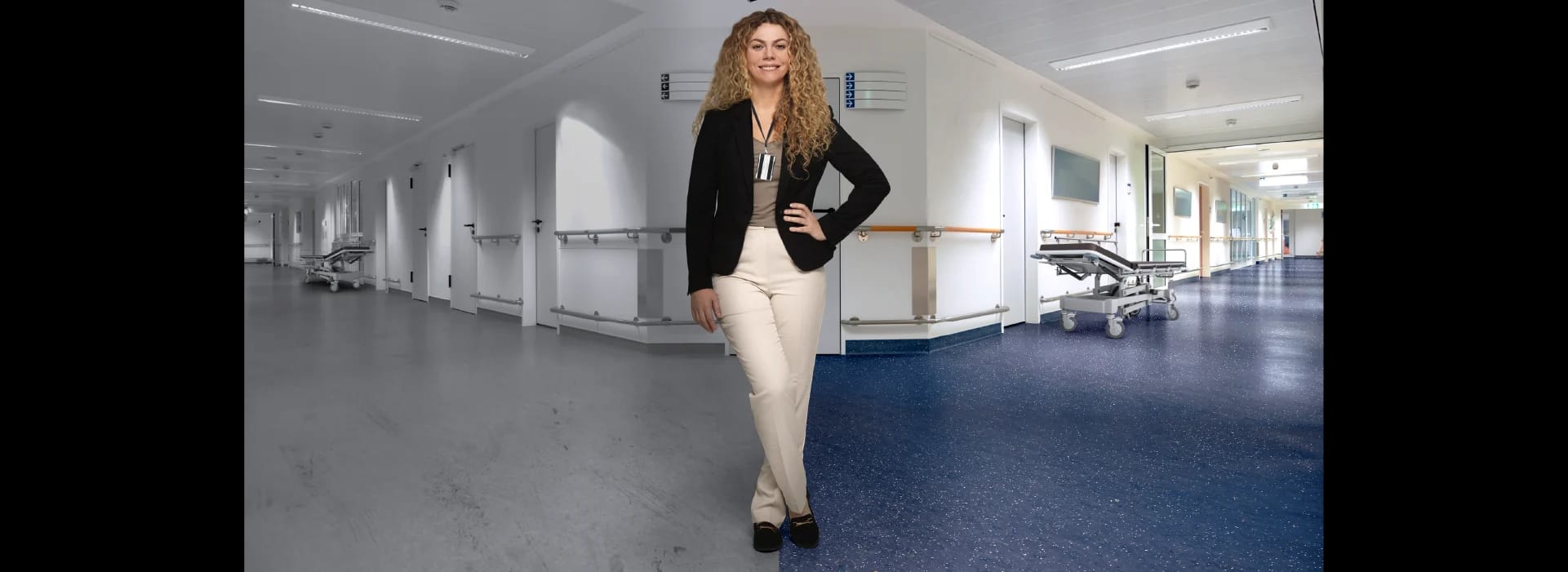 A hospital facility manager stands between two hallways. The left has old flooring; the right has new resilient flooring.