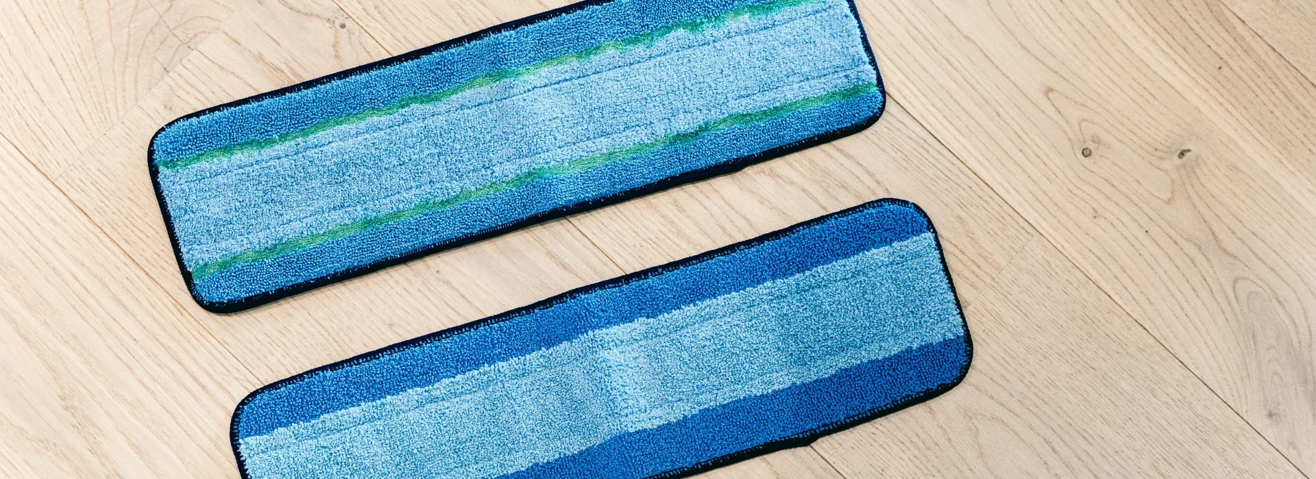 A closeup of the Bona Microfiber Cleaning Pad and the Microfiber PowerPlus Deep Clean Pad shows dual zone cleaning action.